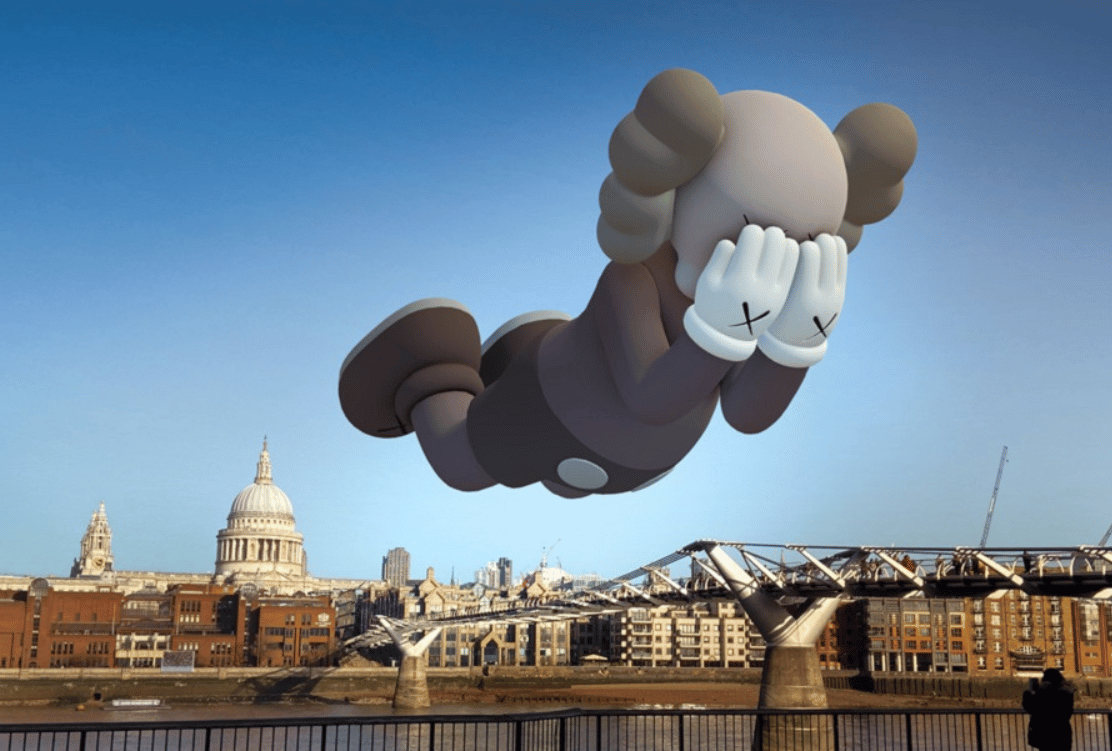 A 3D animated figure of a sheep floating above London's skyline, covering its eyes with its hands, creating an amusing and surreal scene against the backdrop of St. Paul's Cathedral.