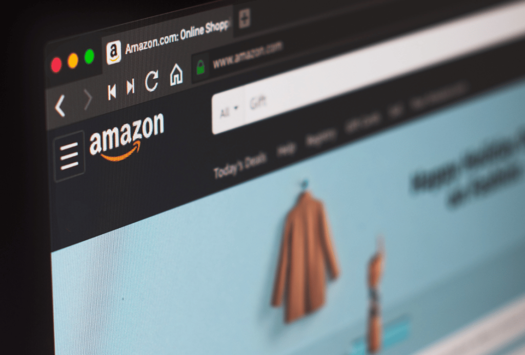 Close-up view of a computer screen displaying the Amazon website homepage with a blurred shopping section.