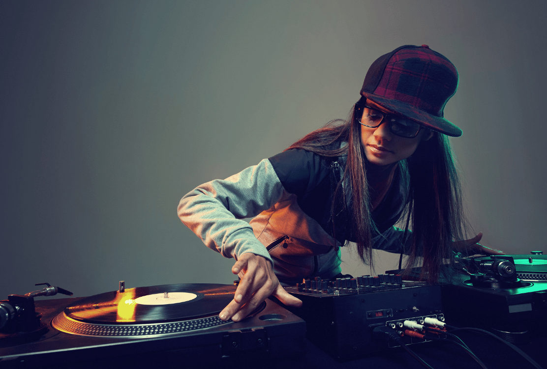 Female DJ mixing on turntables, symbolizing mastery in digital marketing and SEO trends.
