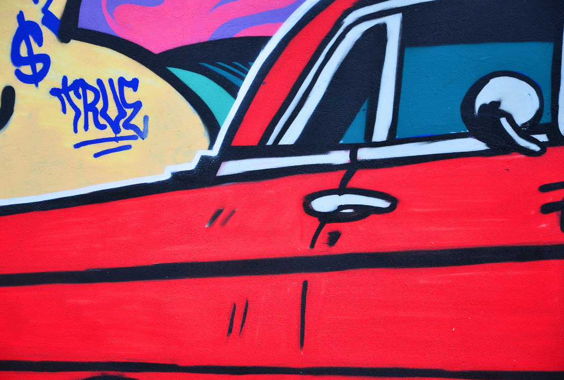 Vibrant graffiti art showcasing a stylized car design with bold colors.