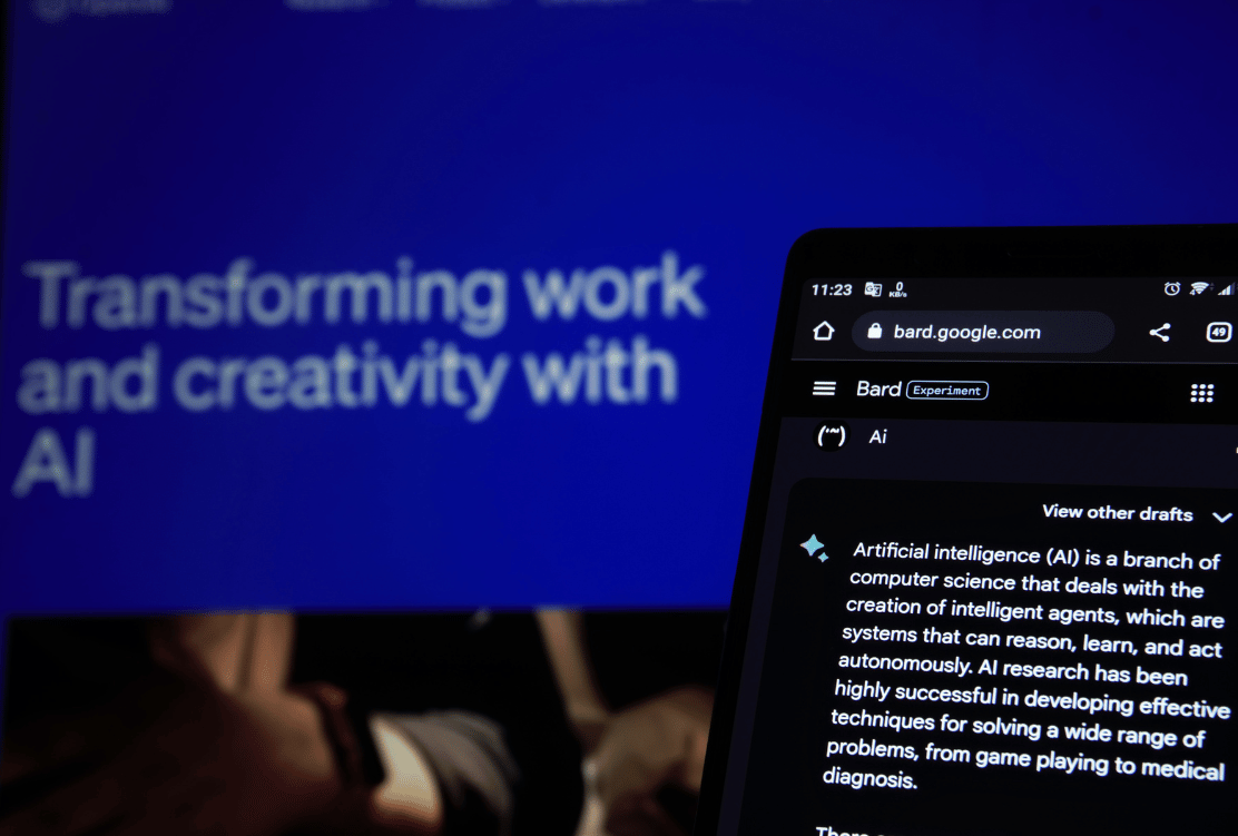 A tablet screen with an article titled "Transforming work and creativity with AI" next to another device featuring an AI-related draft on bard.google.com.