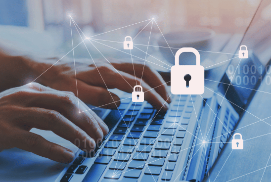 Close-up of hands typing on a laptop keyboard with digital icons of padlocks and a security network overlaying the image.