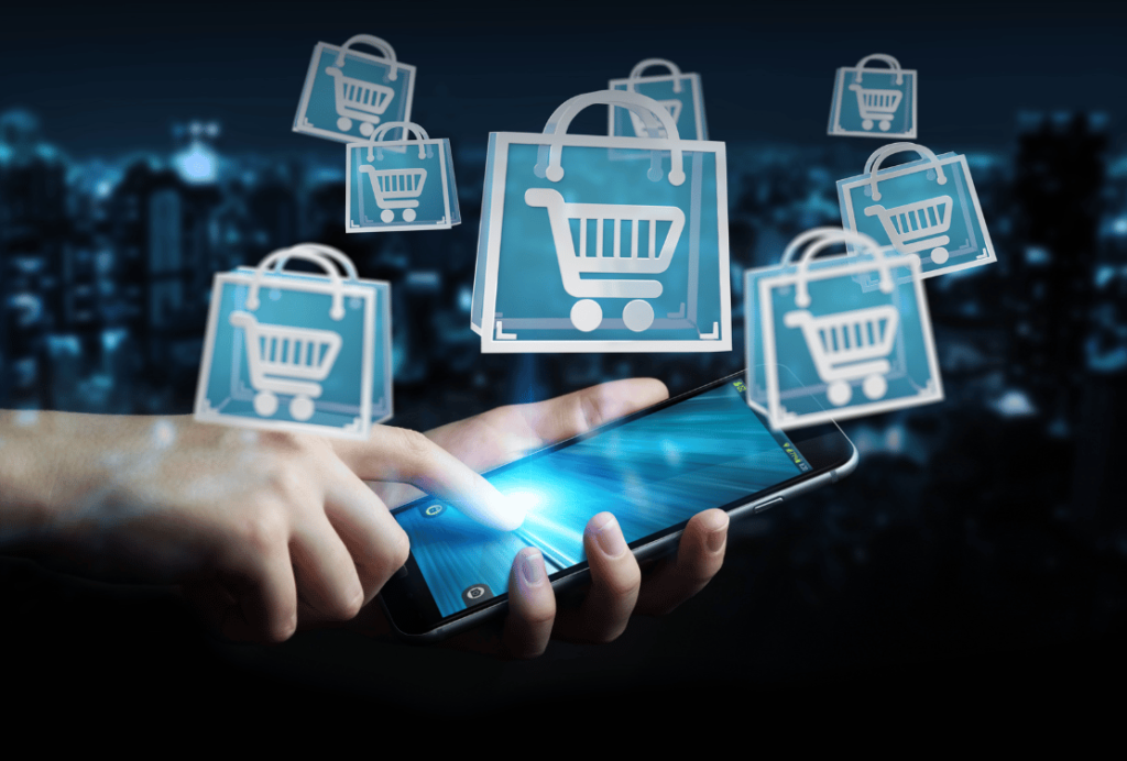 Hands holding a smartphone with shopping cart icons floating above the screen, symbolizing online shopping.