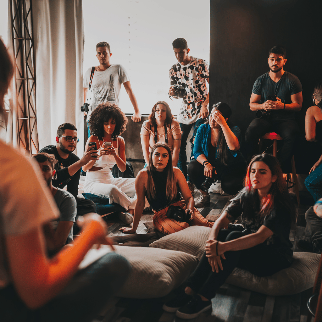 A diverse group of people attentively focusing on a speaker at a modern marketing event.