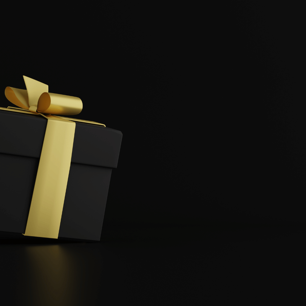 An elegant black gift box with a luxurious golden ribbon against a dark background, symbolizing exclusive Boxing Week deals.